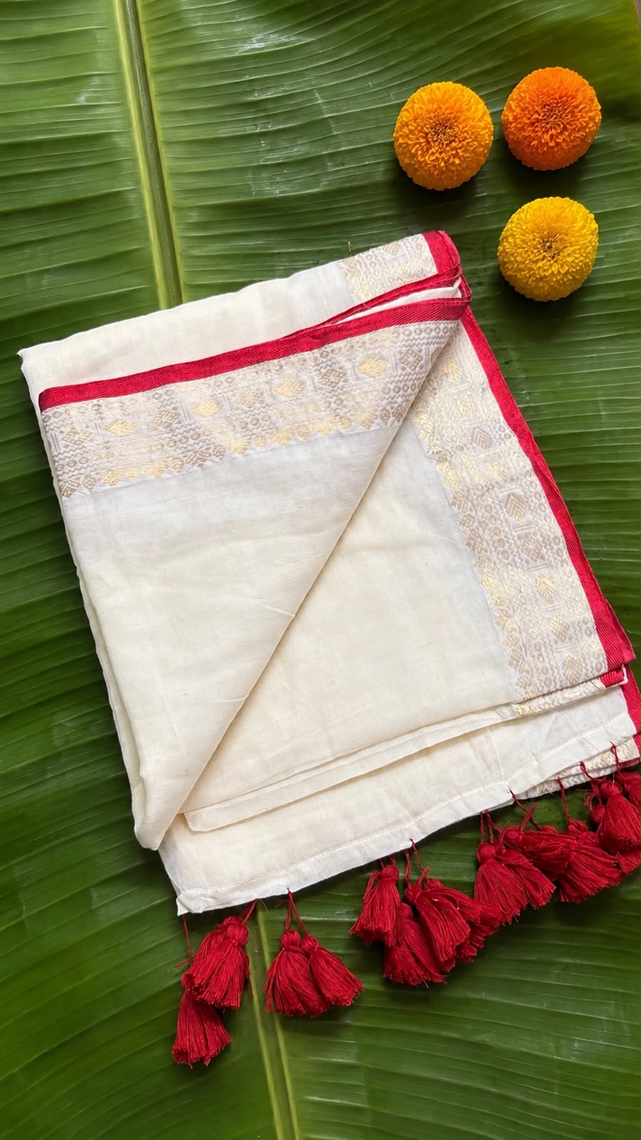 Anamika – Off-White Mul Cotton Saree with Rich Gold Zari Motif Border & Red Piping